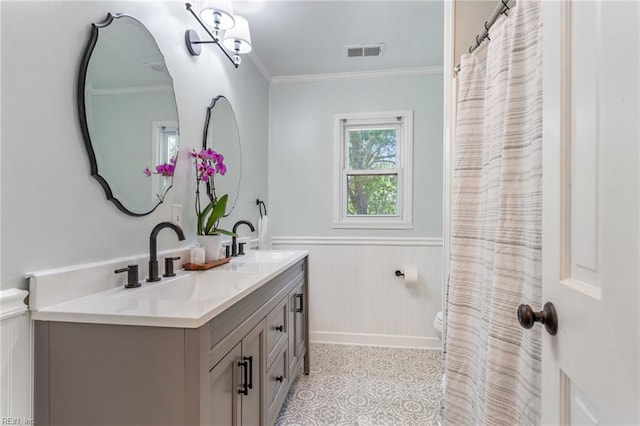 5801 Lancelot Dr, Virginia Beach, VA 23464 - full bathroom featuring double vanity, a wainscoted wall, toilet, crown molding, and tile patterned floors