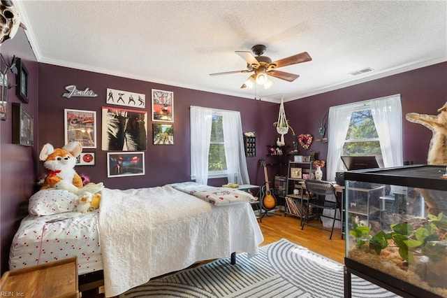 5801 Lancelot Dr, Virginia Beach, VA 23464 - bedroom featuring ornamental molding, wood finished floors, a textured ceiling, and a ceiling fan