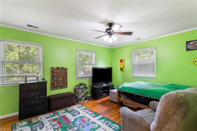 5801 Lancelot Dr, Virginia Beach, VA 23464 - bedroom with ornamental molding, wood finished floors, multiple windows, a textured ceiling, and a ceiling fan