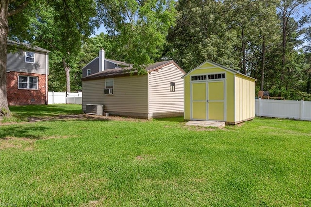 5801 Lancelot Dr, Virginia Beach, VA 23464 - back of property featuring cooling unit, central AC, a chimney, and view of wooded area