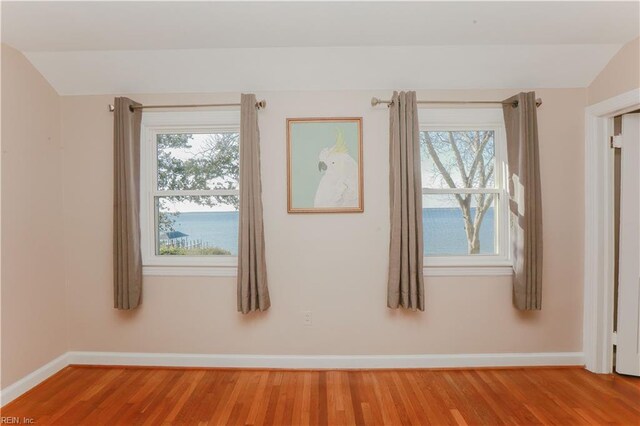 609 River Rd, Newport News, VA 23601 - unfurnished room featuring vaulted ceiling, light wood-type flooring, and baseboards