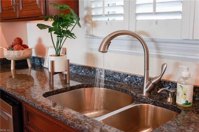 609 River Rd, Newport News, VA 23601 - kitchen view of a sink, dark stone countertops, brown cabinetry, and stainless steel dishwasher