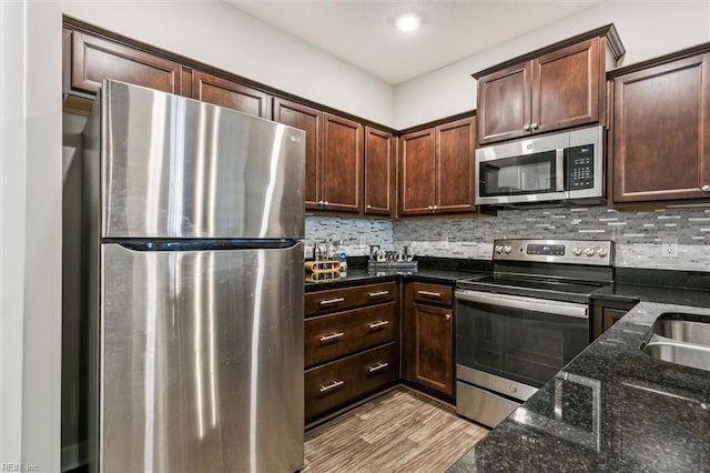 418 Fishers Ct, Hampton, VA 23666 - kitchen with appliances with stainless steel finishes, dark stone counters, decorative backsplash, dark brown cabinetry, and recessed lighting