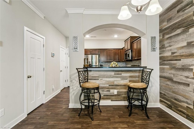 418 Fishers Ct, Hampton, VA 23666 - kitchen with appliances with stainless steel finishes, dark countertops, dark wood-type flooring, crown molding, and arched walkways