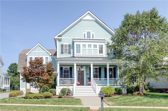 3304 Dodd Dr, Chesapeake, VA 23323 - view of front of house with a standing seam roof, a porch, a front lawn, and metal roof