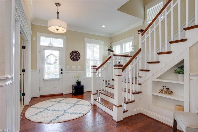 3304 Dodd Dr, Chesapeake, VA 23323 - entrance foyer with healthy amount of natural light, wainscoting, dark wood-style flooring, stairs, and ornamental molding