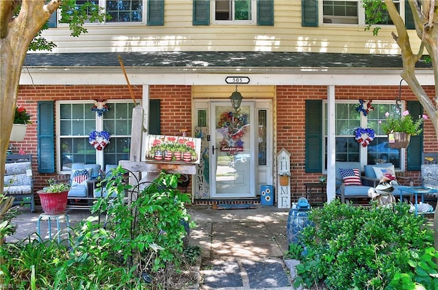 505 Stockton St, Hampton, VA 23669 - doorway to property with brick siding, covered porch, and roof with shingles