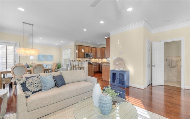 3964 W Stratford Rd, Virginia Beach, VA 23455 - living room with ornamental molding, a chandelier, wood finished floors, recessed lighting, and ceiling fan
