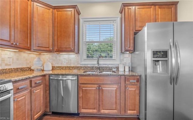 3964 W Stratford Rd, Virginia Beach, VA 23455 - kitchen with stainless steel appliances, a sink, brown cabinets, and stone counters