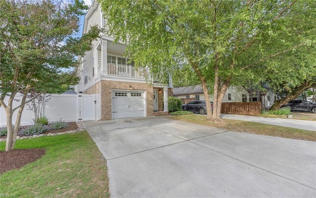 3964 W Stratford Rd, Virginia Beach, VA 23455 - view of front facade with driveway, a balcony, a garage, a gate, and brick siding