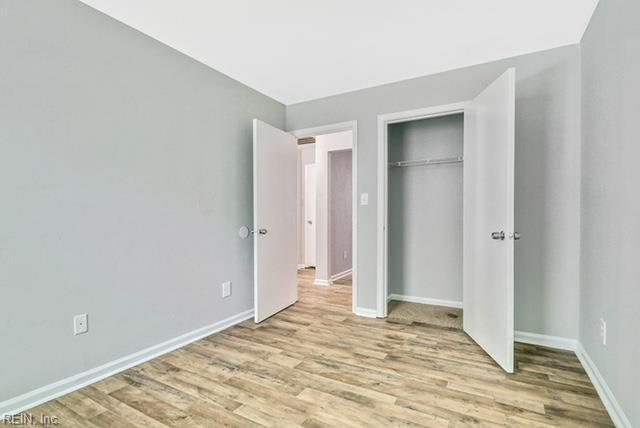 1342 W 39th St, Norfolk, VA 23508 - unfurnished bedroom featuring wood finished floors, baseboards, and a closet