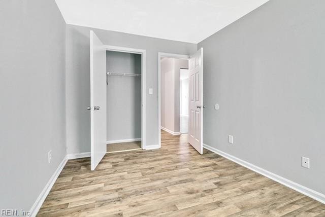 1342 W 39th St, Norfolk, VA 23508 - unfurnished bedroom with light wood finished floors, baseboards, and a closet