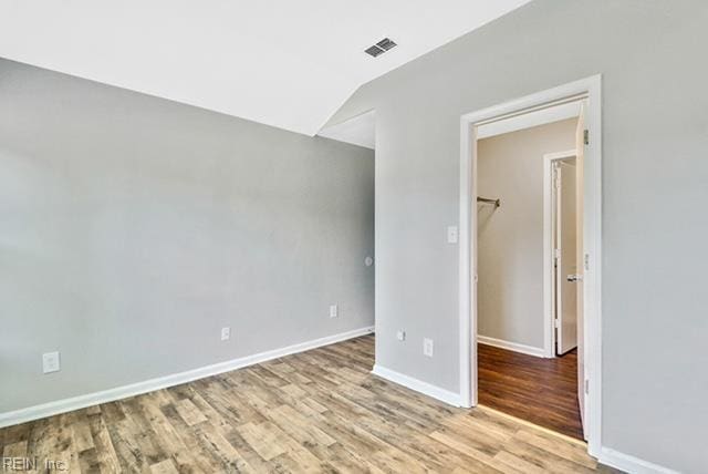 1342 W 39th St, Norfolk, VA 23508 - spare room with wood finished floors, baseboards, and lofted ceiling