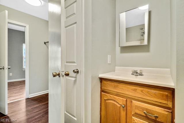 1342 W 39th St, Norfolk, VA 23508 - bathroom with vanity, wood finished floors, and baseboards