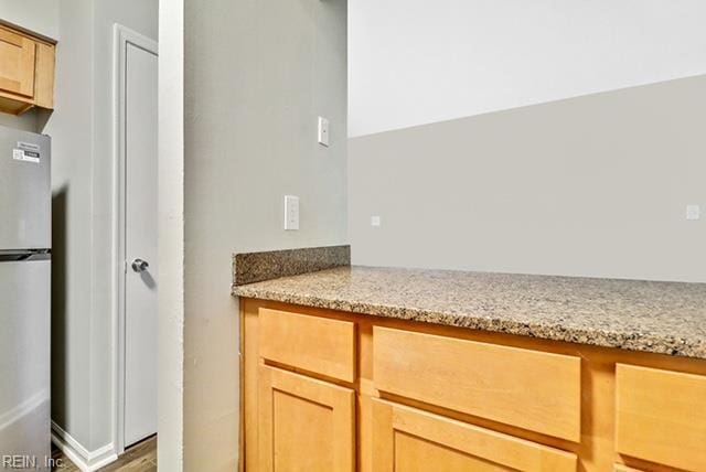 1342 W 39th St, Norfolk, VA 23508 - kitchen featuring freestanding refrigerator, light stone countertops, and wood finished floors
