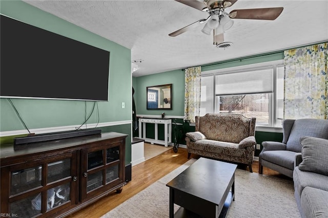 109 Sykes Ave, Portsmouth, VA 23701 - living area with wood finished floors, ceiling fan, a textured ceiling, and baseboards