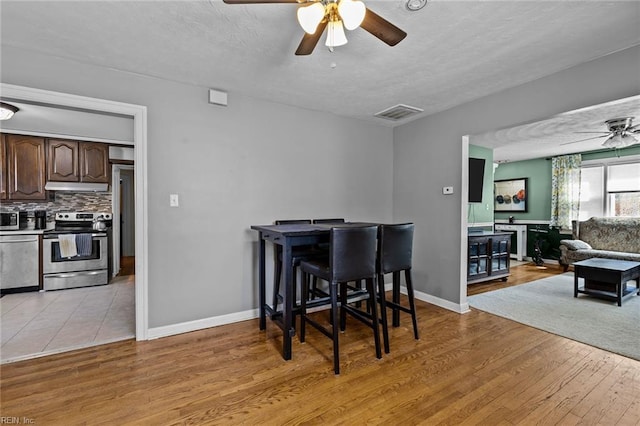 109 Sykes Ave, Portsmouth, VA 23701 - dining space with a ceiling fan, a textured ceiling, light wood-style floors, and baseboards