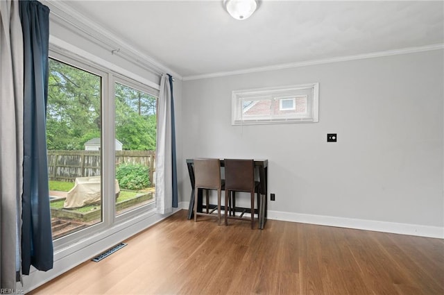 8 Llewellyn St, Portsmouth, VA 23707 - dining area with wood finished floors, crown molding, healthy amount of natural light, and baseboards