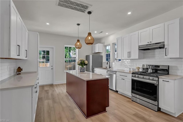 1028 W 36th St, Norfolk, VA 23508 - kitchen featuring appliances with stainless steel finishes, under cabinet range hood, backsplash, light countertops, and recessed lighting