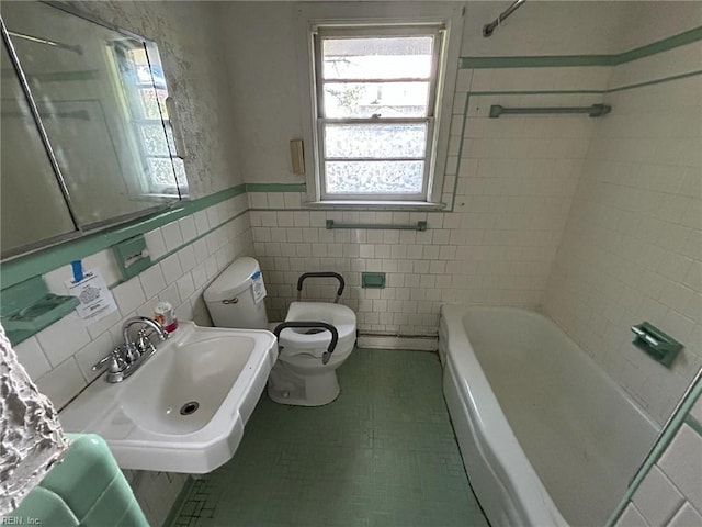1702 Marshall Ave, Newport News, VA 23607 - bathroom with toilet, a sink, tile walls, wainscoting, and tile patterned floors