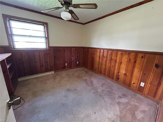 1702 Marshall Ave, Newport News, VA 23607 - carpeted empty room featuring wainscoting, wood walls, a textured ceiling, and ceiling fan
