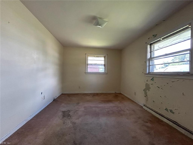 1702 Marshall Ave, Newport News, VA 23607 - carpeted empty room featuring a baseboard heating unit and baseboards