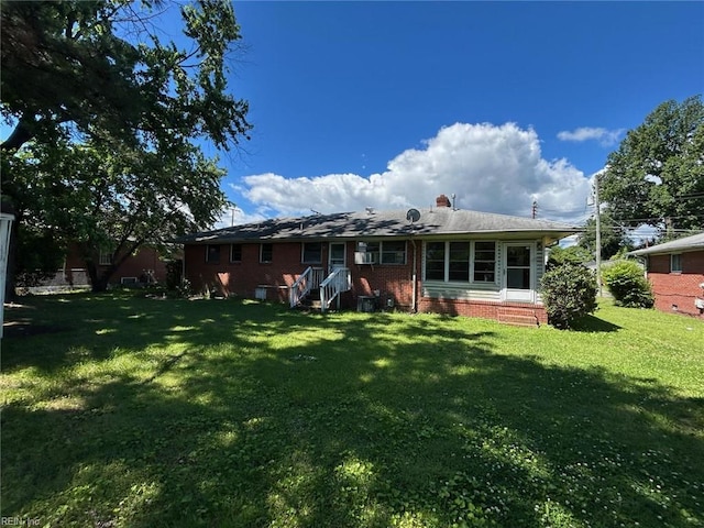 1702 Marshall Ave, Newport News, VA 23607 - rear view of house featuring a lawn and a chimney