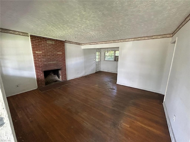 1702 Marshall Ave, Newport News, VA 23607 - unfurnished living room with a textured ceiling, wood finished floors, a brick fireplace, crown molding, and baseboards