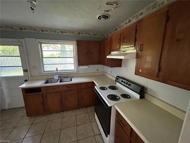 1702 Marshall Ave, Newport News, VA 23607 - kitchen with white electric stove, under cabinet range hood, a sink, brown cabinets, and light countertops