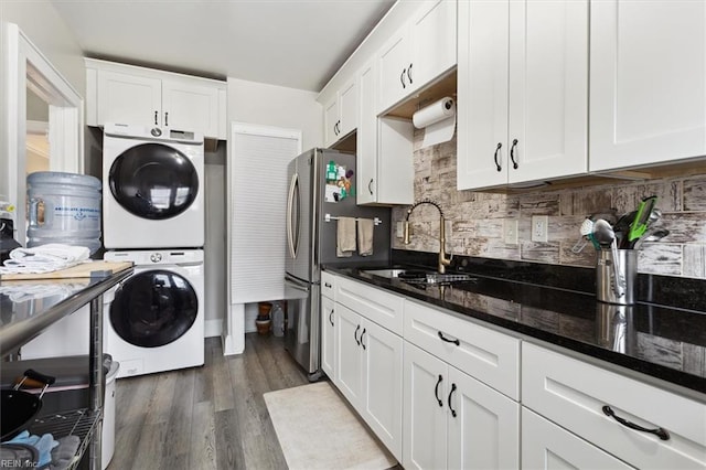 1505 Meads Rd Unit A-2, Norfolk, VA 23505 - kitchen featuring stacked washer / dryer, a sink, freestanding refrigerator, white cabinetry, and decorative backsplash
