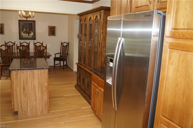 9 Chowning Dr, Hampton, VA 23664 - kitchen featuring stainless steel refrigerator with ice dispenser, light wood-style flooring, dark stone counters, a chandelier, and brown cabinetry