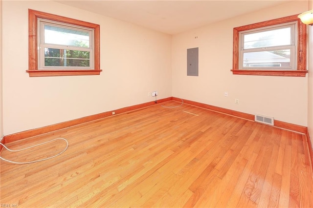 101 Elmhurst Ln, Portsmouth, VA 23701 - unfurnished room featuring electric panel, light wood-style floors, and baseboards