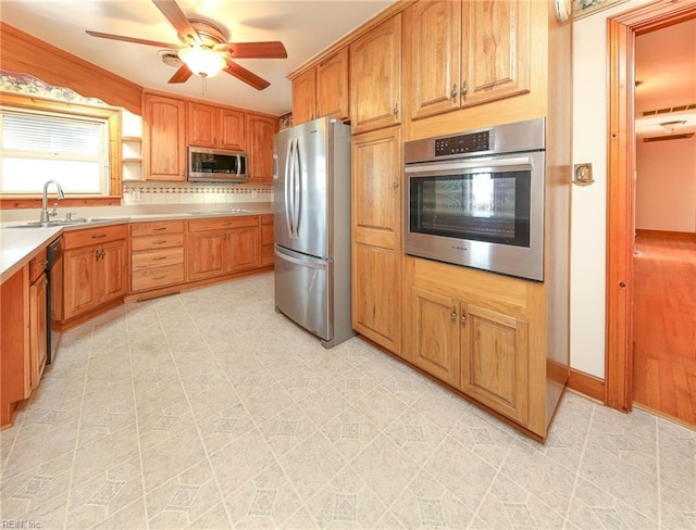 101 Elmhurst Ln, Portsmouth, VA 23701 - kitchen featuring stainless steel appliances, a sink, ceiling fan, light countertops, and tasteful backsplash