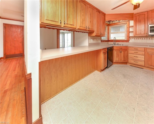101 Elmhurst Ln, Portsmouth, VA 23701 - kitchen featuring black dishwasher, a sink, white microwave, light countertops, and backsplash