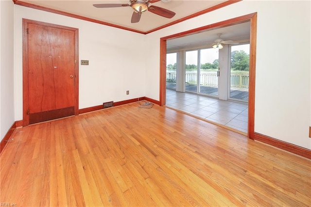 101 Elmhurst Ln, Portsmouth, VA 23701 - empty room featuring a ceiling fan, ornamental molding, baseboards, wood-type flooring, and a water view