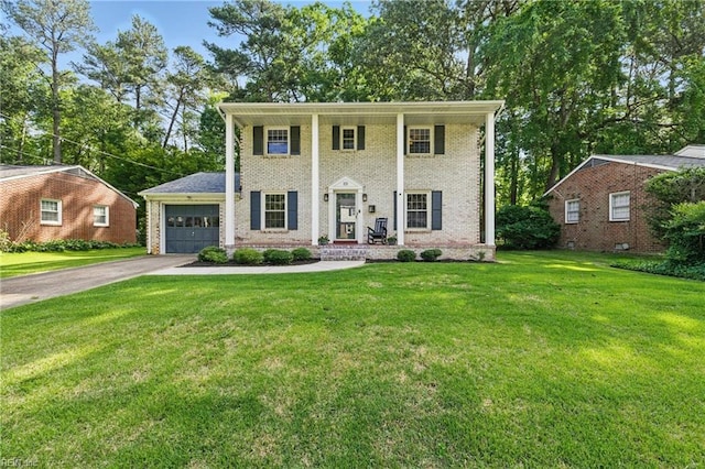101 Huxley Pl, Newport News, VA 23606 - greek revival house featuring an attached garage, concrete driveway, a front lawn, and brick siding
