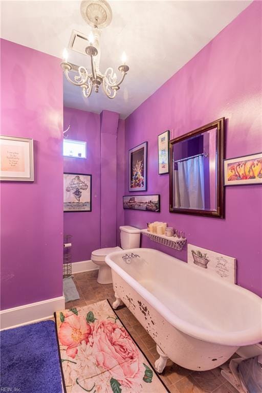 218 Mt Vernon Ave, Portsmouth, VA 23707 - bathroom with a chandelier, toilet, a bath, and baseboards