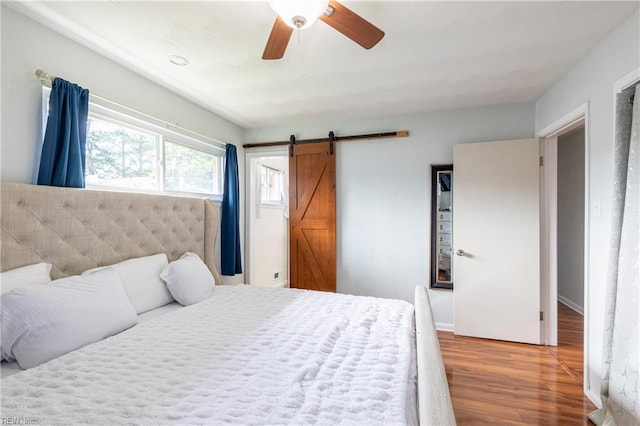8121 Walters Dr, Norfolk, VA 23518 - bedroom featuring wood finished floors, a barn door, and ceiling fan