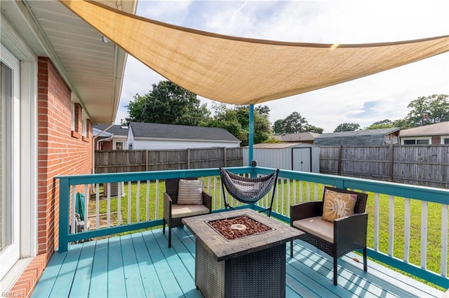 8121 Walters Dr, Norfolk, VA 23518 - deck with an outdoor fire pit, a shed, and a fenced backyard