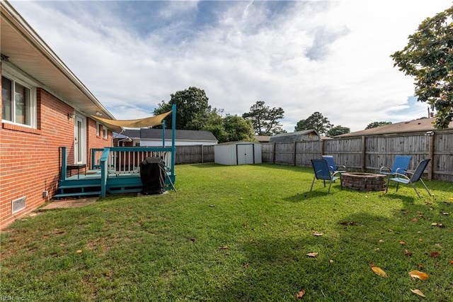 8121 Walters Dr, Norfolk, VA 23518 - fenced backyard with a deck, a storage shed, and a fire pit