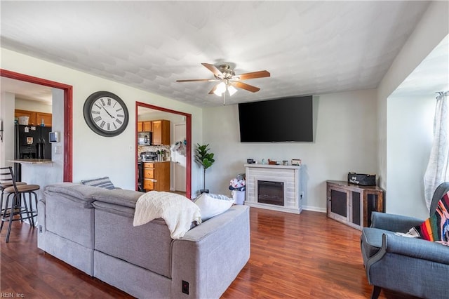 8121 Walters Dr, Norfolk, VA 23518 - living room with dark wood-type flooring, ceiling fan, and a fireplace
