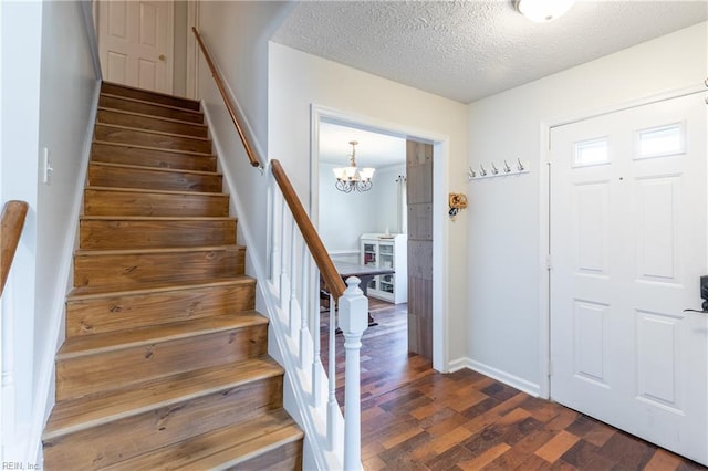 11 Thomas Athey Ct, Hampton, VA 23666 - foyer entrance with stairs, dark wood-style floors, a textured ceiling, a chandelier, and baseboards
