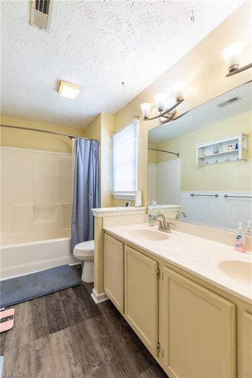 11 Thomas Athey Ct, Hampton, VA 23666 - full bath featuring double vanity, wood finished floors, shower / tub combo, toilet, and a textured ceiling