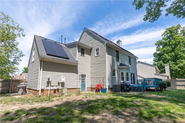 11 Thomas Athey Ct, Hampton, VA 23666 - back of property featuring roof mounted solar panels, a chimney, a deck, and central air condition unit