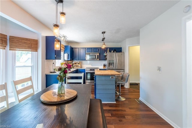 11 Thomas Athey Ct, Hampton, VA 23666 - kitchen with stainless steel appliances, blue cabinets, wooden counters, tasteful backsplash, and a textured ceiling