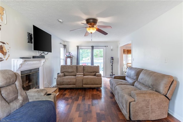 11 Thomas Athey Ct, Hampton, VA 23666 - living room featuring a ceiling fan, dark wood-style flooring, a glass covered fireplace, and baseboards