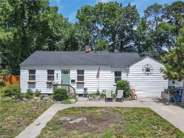611 74th St, Newport News, VA 23605 - view of front facade featuring a chimney, roof with shingles, and a patio