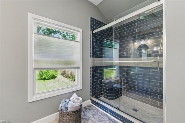 611 74th St, Newport News, VA 23605 - bathroom featuring a stall shower, baseboards, and vaulted ceiling