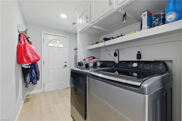611 74th St, Newport News, VA 23605 - laundry area featuring cabinet space, washing machine and dryer, light wood-style flooring, and baseboards