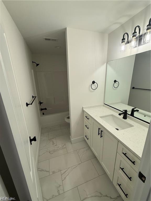 617 Dam Neck Rd, Virginia Beach, VA 23454 - full bath featuring marble finish floors, vanity, baseboards, toilet, and shower / washtub combination